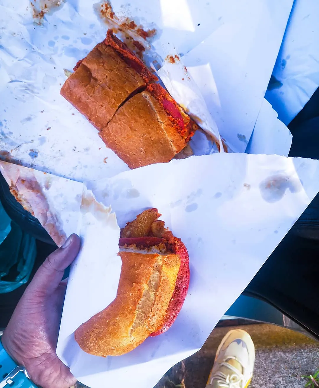 Two pieces of a Gatsby in paper, held in hand.